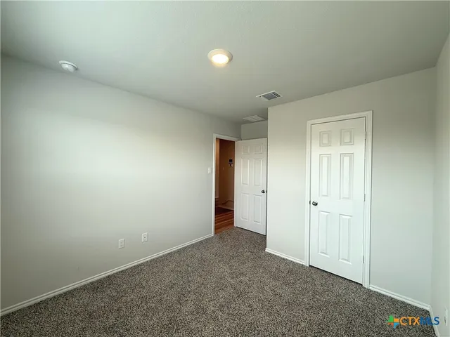 an empty room with closet area