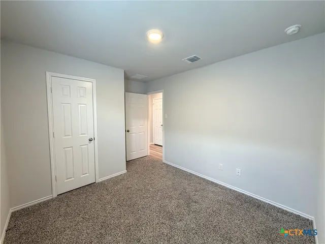 a view of an empty room and closet area