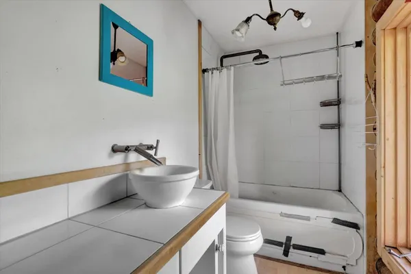 a backyard of a house with wooden floor and outdoor seating