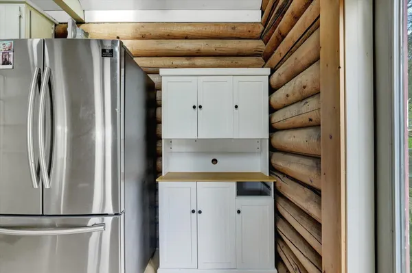 a kitchen with a refrigerator and cabinets