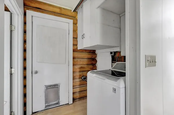 a kitchen with a refrigerator and cabinets