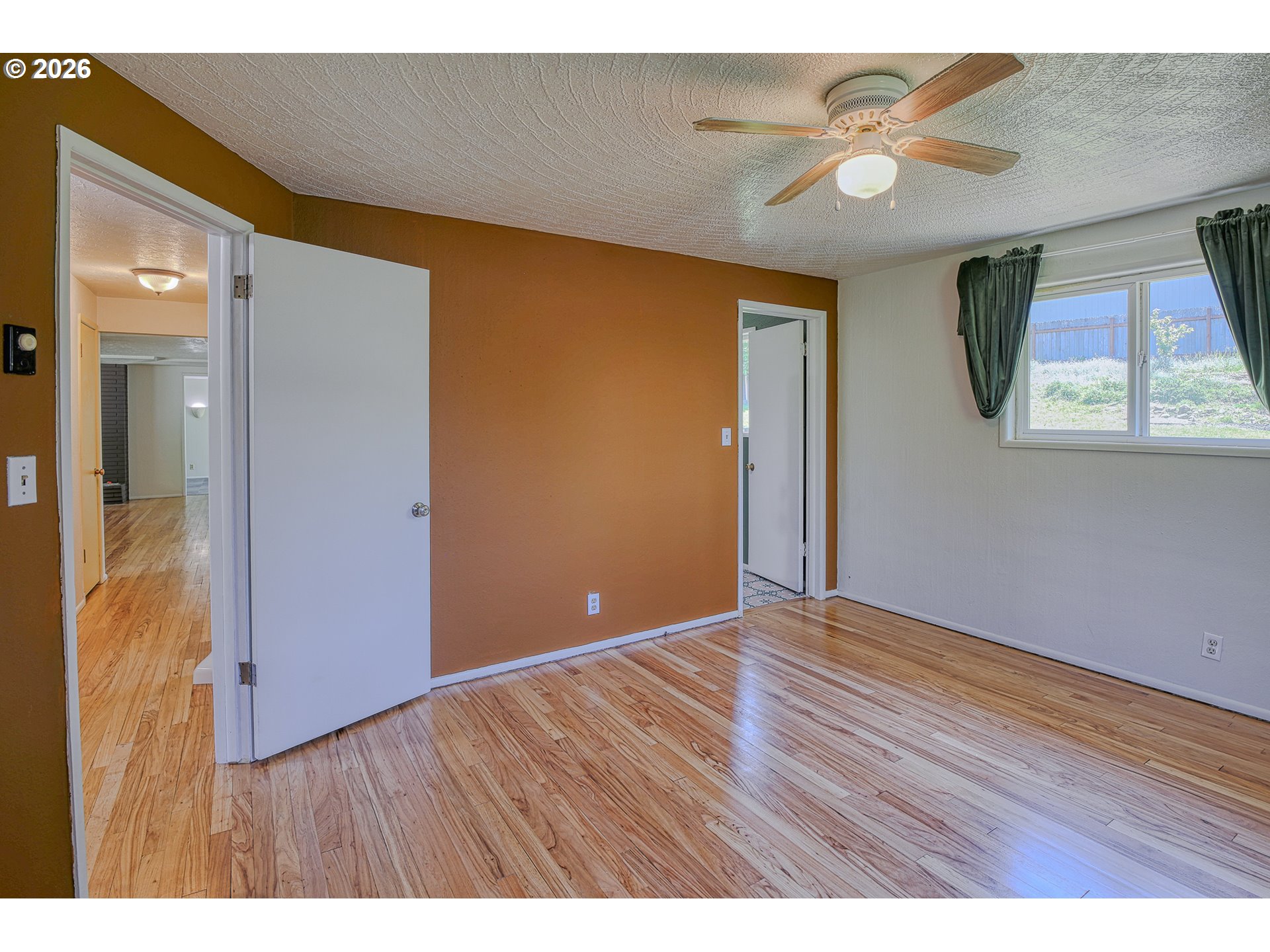 7077 Main Street Springfield, OR 97478 - Photo 15 of 34 a view of an empty room with window and wooden floor
