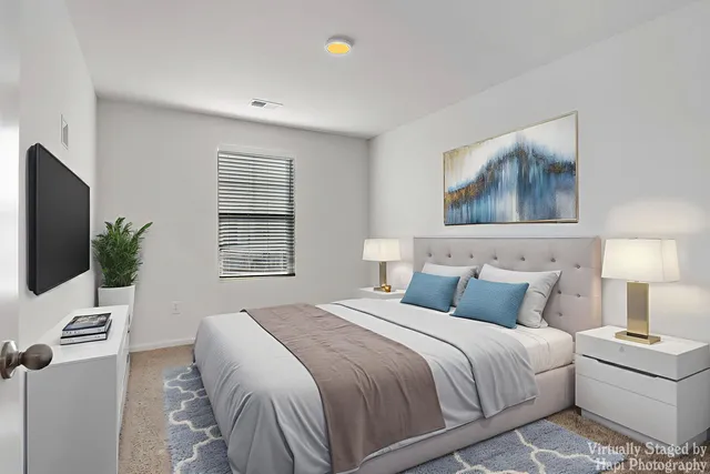 a bedroom with a bed and a flat screen tv