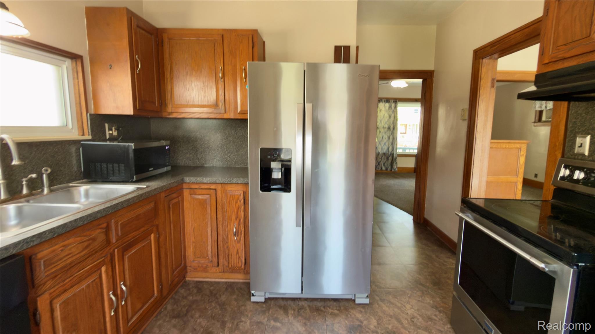130 Elm Street River Rouge, MI 48218 - Photo 14 of 20 Kitchen featuring wood cabinetry, stainless steel side-by-side refrigerator, double basin sink, and ample counter space