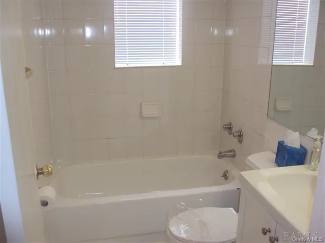 a bathroom with a bathtub a toilet a sink and a shower