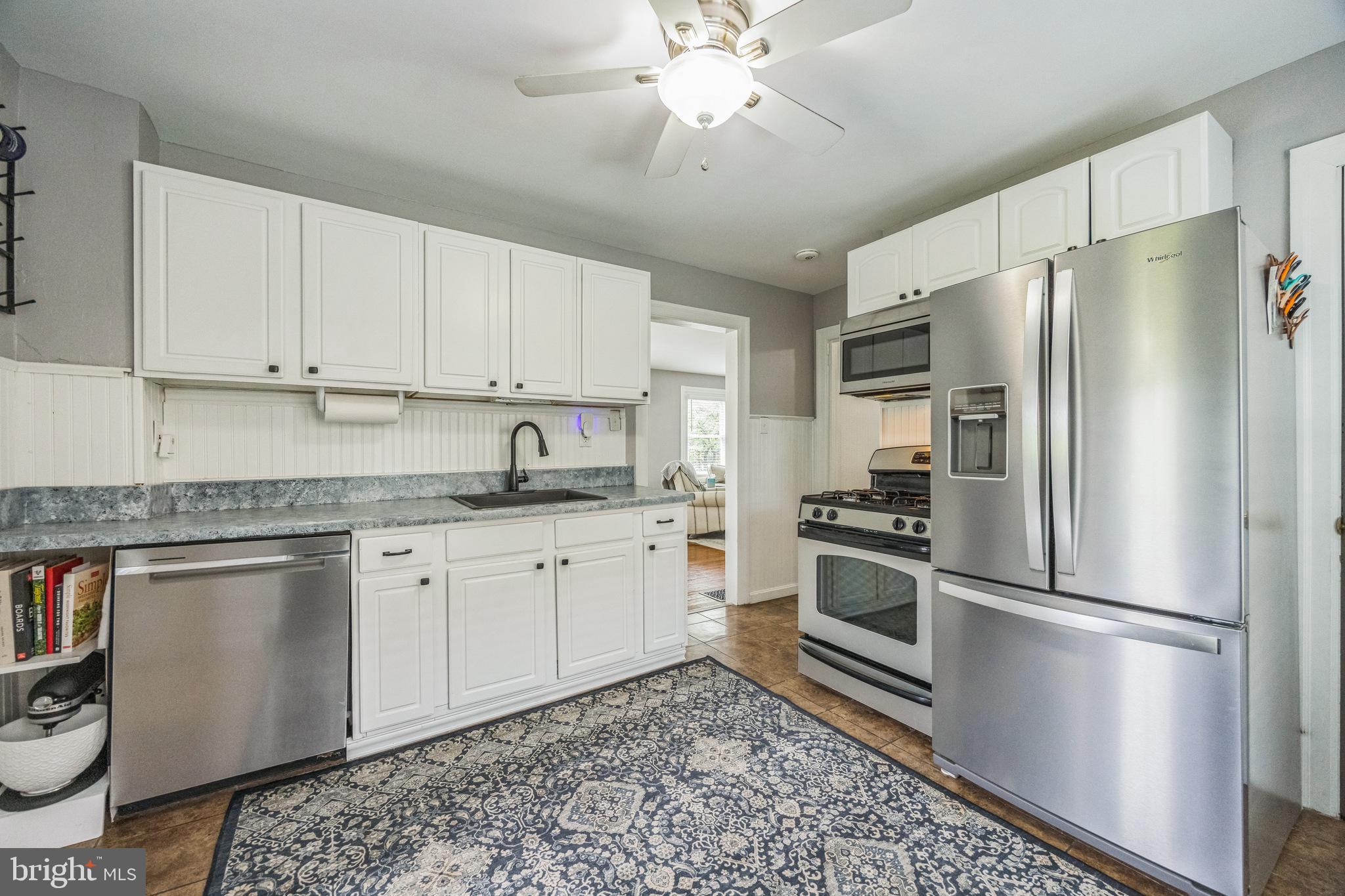 665 U Street King of Prussia, PA 19406 - Photo 11 of 26 a kitchen with stainless steel appliances granite countertop a refrigerator a sink dishwasher a stove with white cabinets