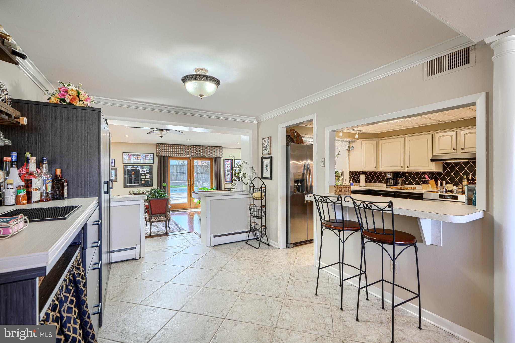 2118 Eastridge Road Lutherville-Timonium, MD 21093 - Photo 13 of 49 a kitchen with a dining table chairs and a refrigerator