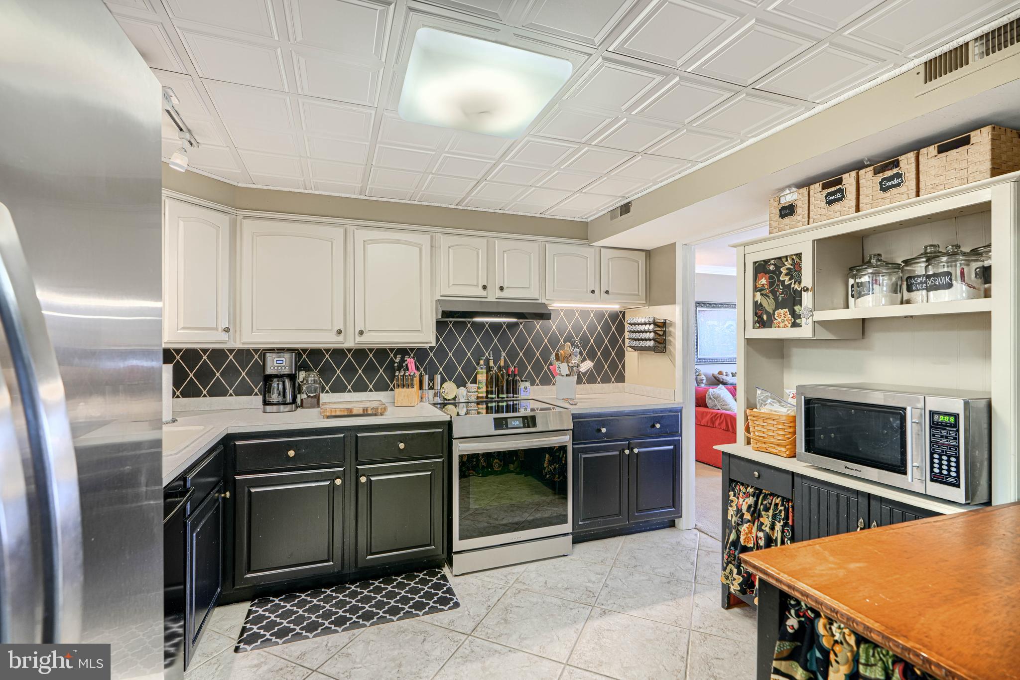 2118 Eastridge Road Lutherville-Timonium, MD 21093 - Photo 20 of 49 a kitchen with stainless steel appliances granite countertop a stove and a refrigerator