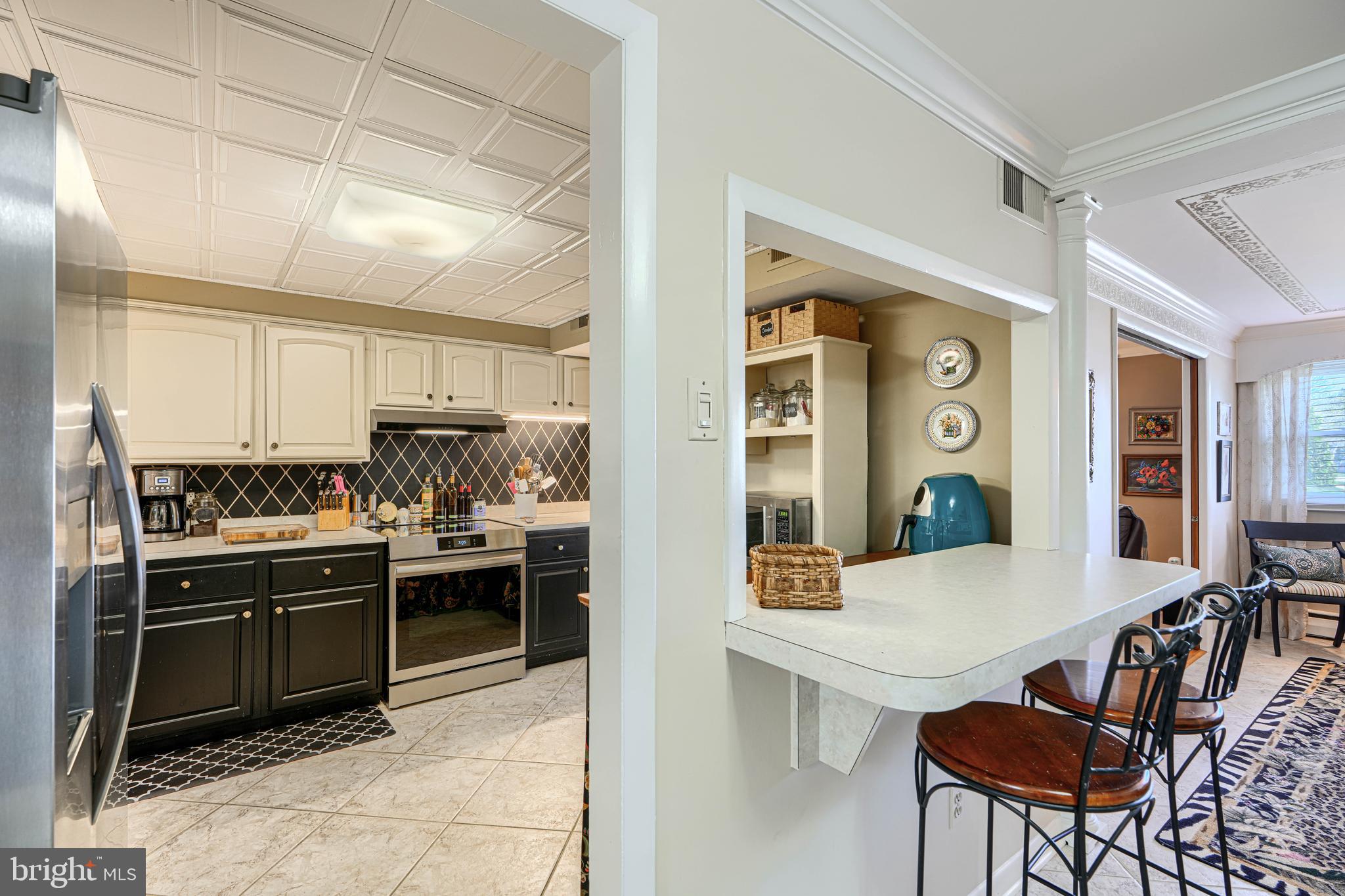 2118 Eastridge Road Lutherville-Timonium, MD 21093 - Photo 22 of 49 a kitchen with stainless steel appliances kitchen island granite countertop a sink and cabinets