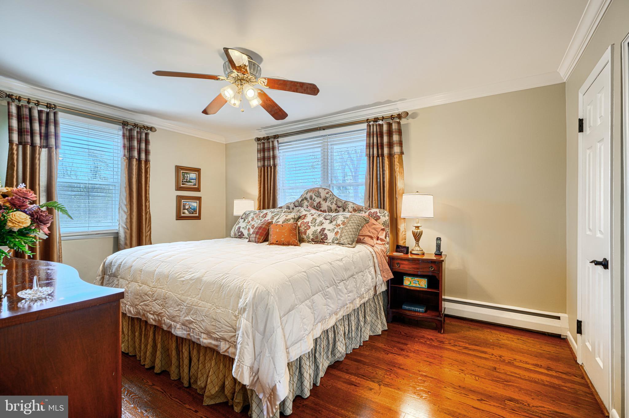 2118 Eastridge Road Lutherville-Timonium, MD 21093 - Photo 26 of 49 a bedroom with a bed a chandelier and dresser