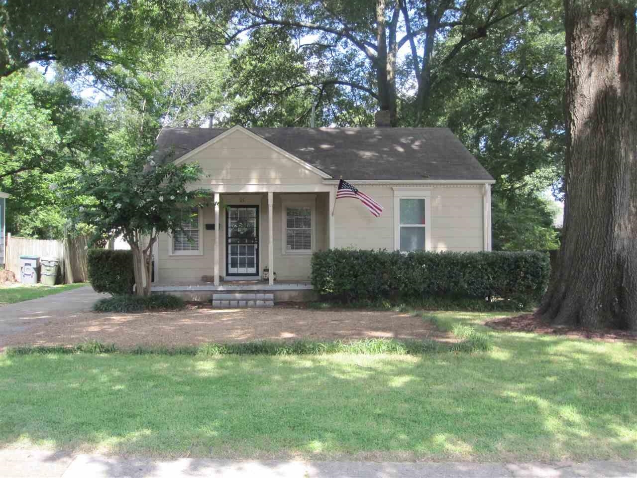 Bungalow-style home with a front lawn and covered porch