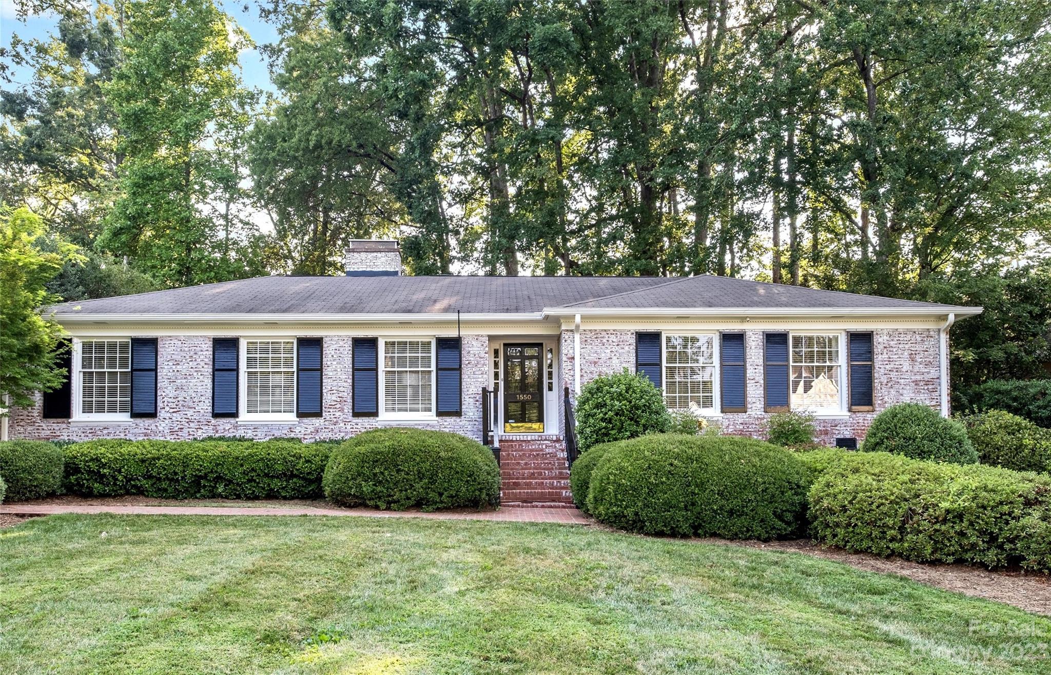 1550 Coventry Road Charlotte, NC 28211 - Photo 1 of 31 a view of a house next to a big yard and large trees