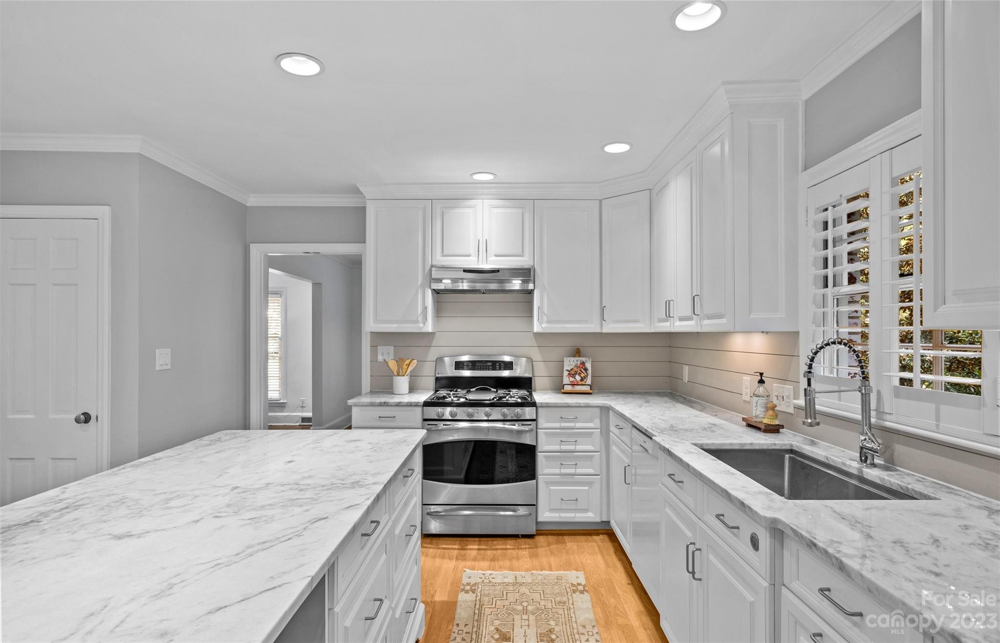 1550 Coventry Road Charlotte, NC 28211 - Photo 11 of 31 a kitchen with granite countertop a sink stove and cabinets