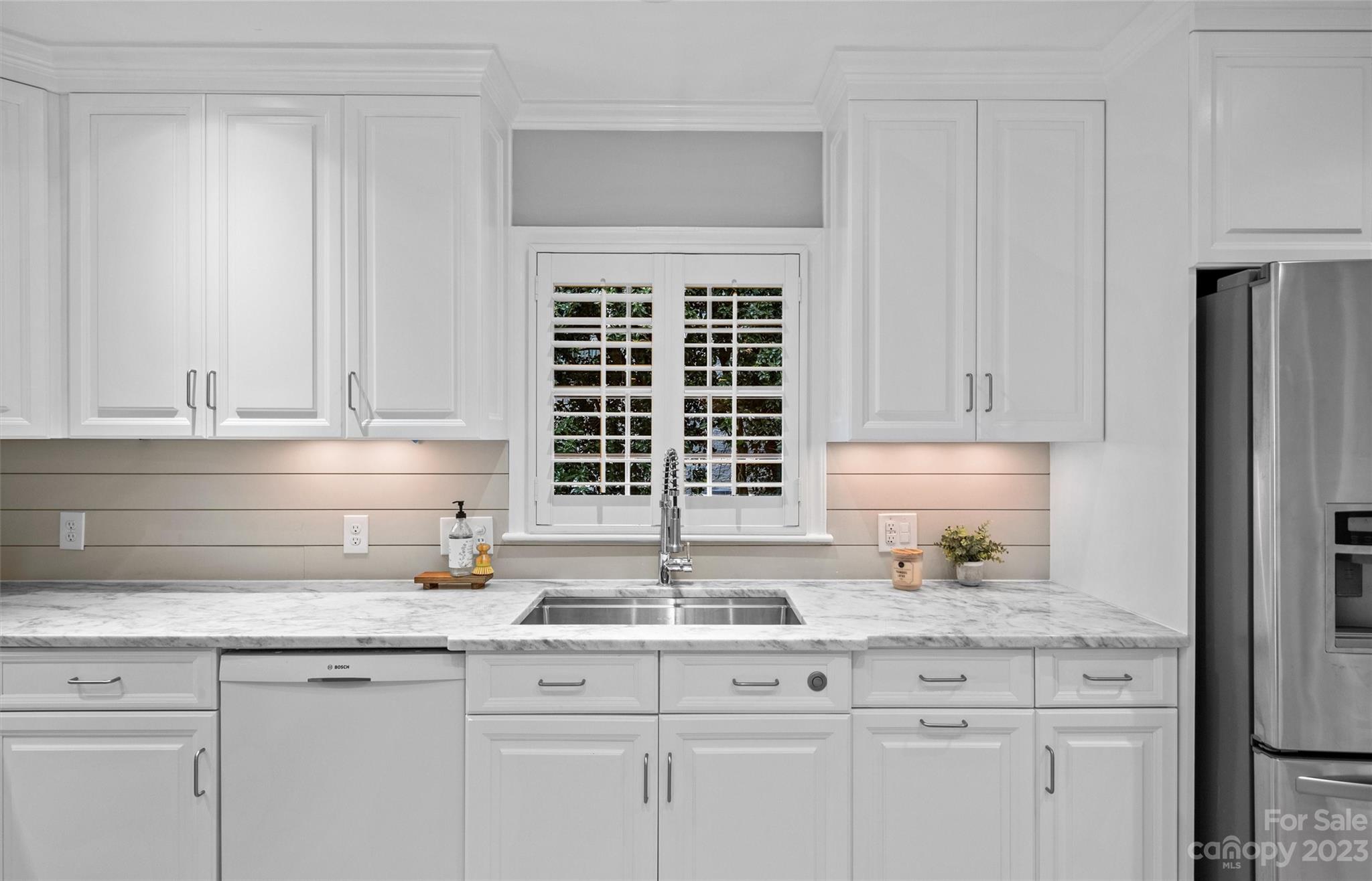 1550 Coventry Road Charlotte, NC 28211 - Photo 12 of 31 a kitchen with granite countertop a sink and a white wooden cabinets