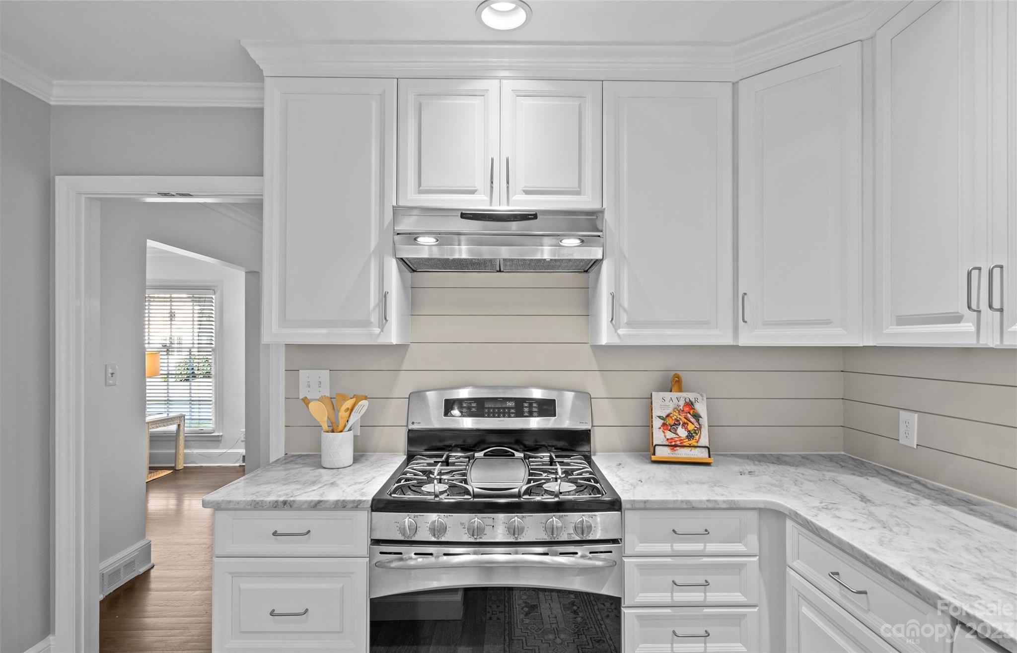 1550 Coventry Road Charlotte, NC 28211 - Photo 13 of 31 a kitchen with granite countertop white cabinets and stainless steel appliances