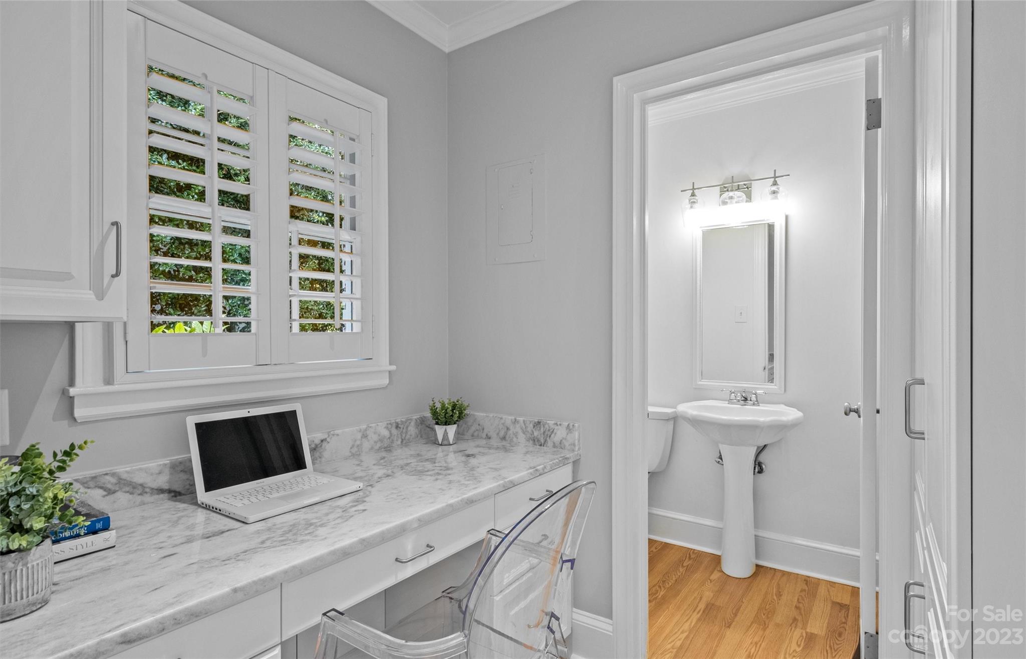 1550 Coventry Road Charlotte, NC 28211 - Photo 16 of 31 a bathroom with a granite countertop sink a toilet and a window