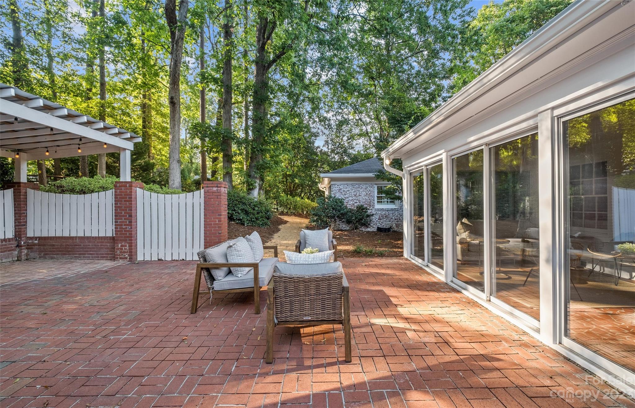 1550 Coventry Road Charlotte, NC 28211 - Photo 26 of 31 a backyard of a house with a garden and outdoor seating
