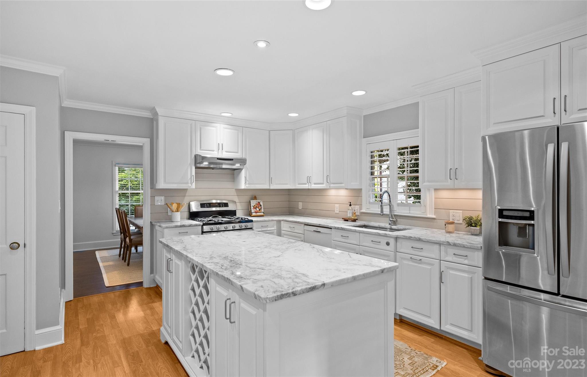 1550 Coventry Road Charlotte, NC 28211 - Photo 10 of 31 a kitchen with stainless steel appliances granite countertop a refrigerator a stove a sink a dining table and chairs