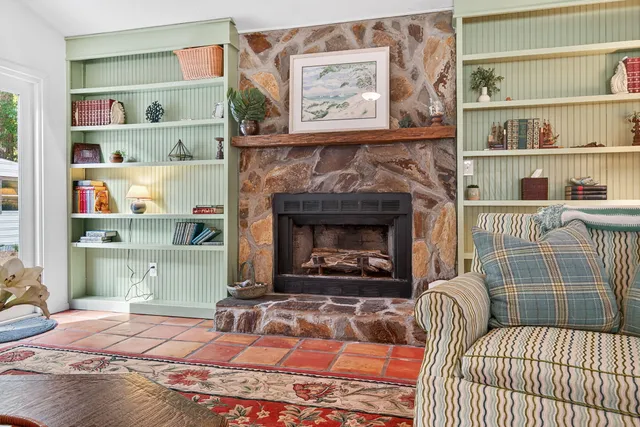 a bedroom with furniture and a fireplace