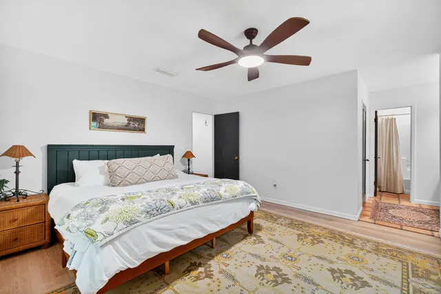 a bedroom with a large bed and a large window