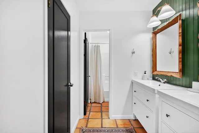 a bathroom with a double vanity sink and a mirror