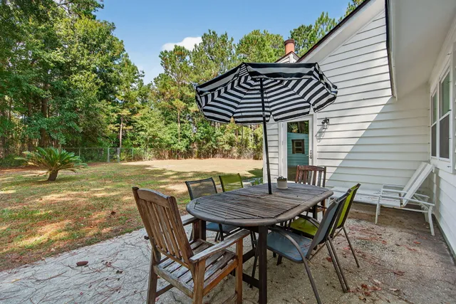 a view of patio with table and chairs and potted plants