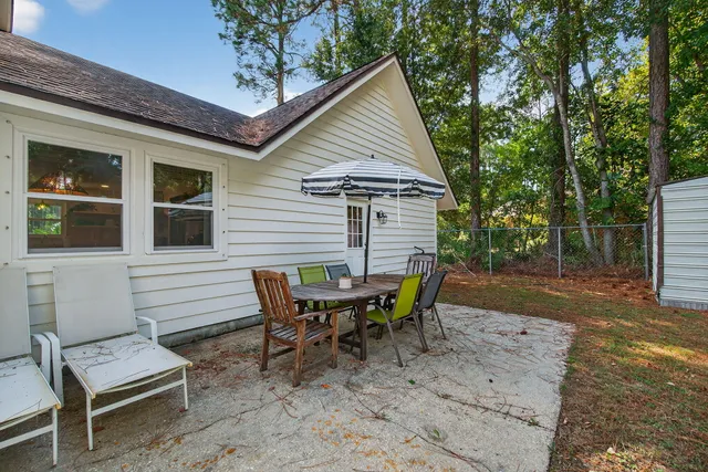 a view of a house with patio and a yard