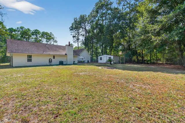 a house view with swimming pool in front of it