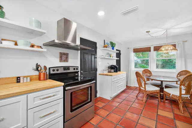 a kitchen with a stove a sink and a stove top oven