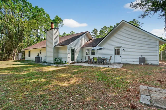 a view of a house with a yard patio and swimming pool