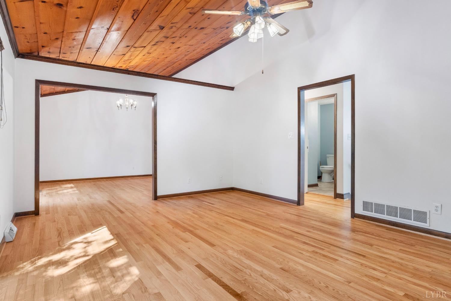 594 Viewmont Drive Evington, VA 24550 - Photo 16 of 43 a view of an empty room with wooden floor and a ceiling fan