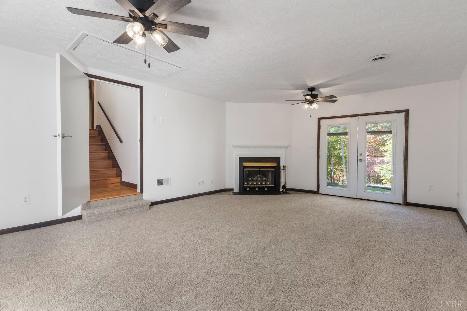 594 Viewmont Drive Evington, VA 24550 - Photo 5 of 43 an empty room with windows and fan