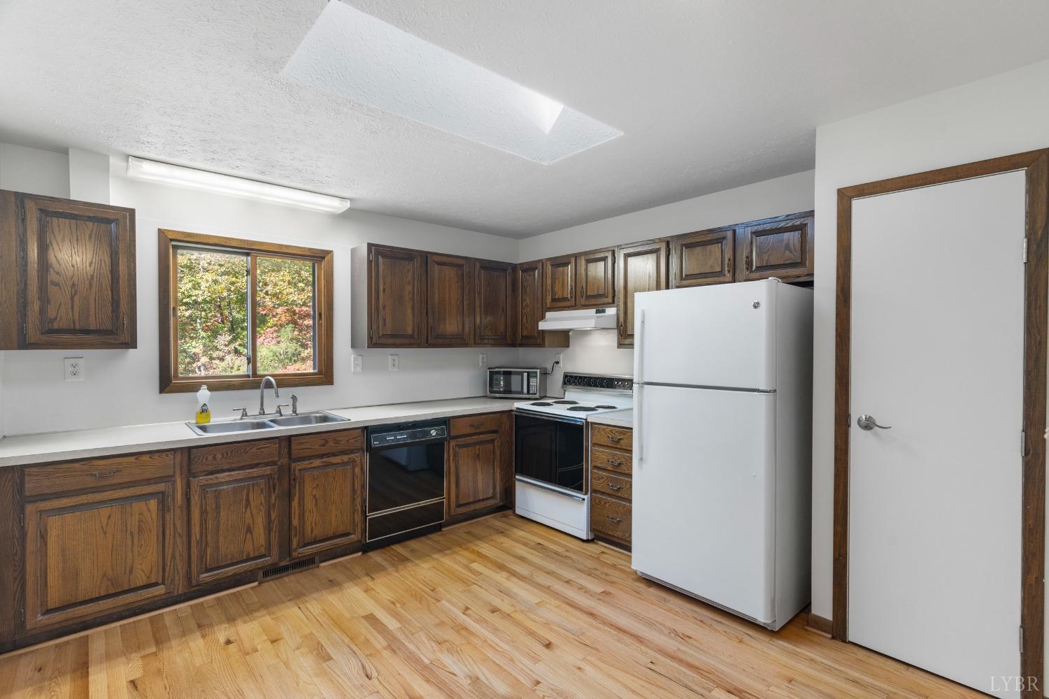 594 Viewmont Drive Evington, VA 24550 - Photo 10 of 43 a kitchen with a sink a refrigerator and window