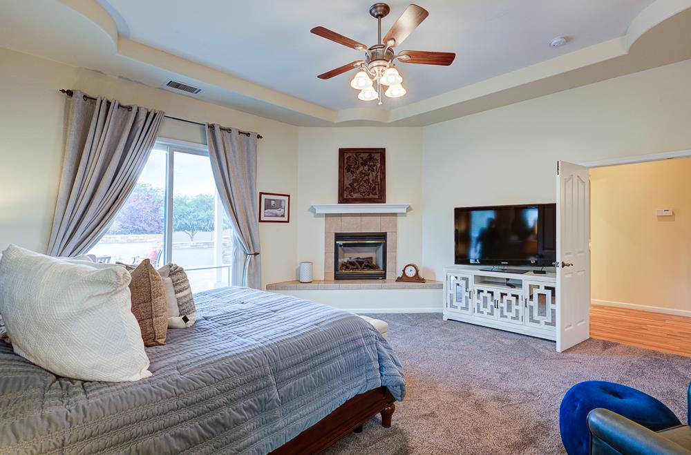 17465 Monreal Road Madera, CA 93636 - Photo 33 of 59 a bedroom with a bed and a flat screen tv
