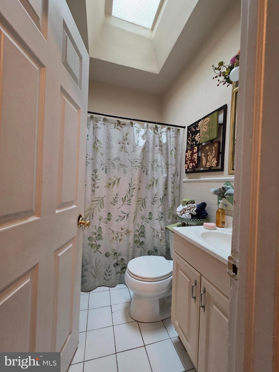 20 South Orange Street Media, PA 19063 - Photo 14 of 18 a bathroom with a granite countertop sink a toilet and a shower