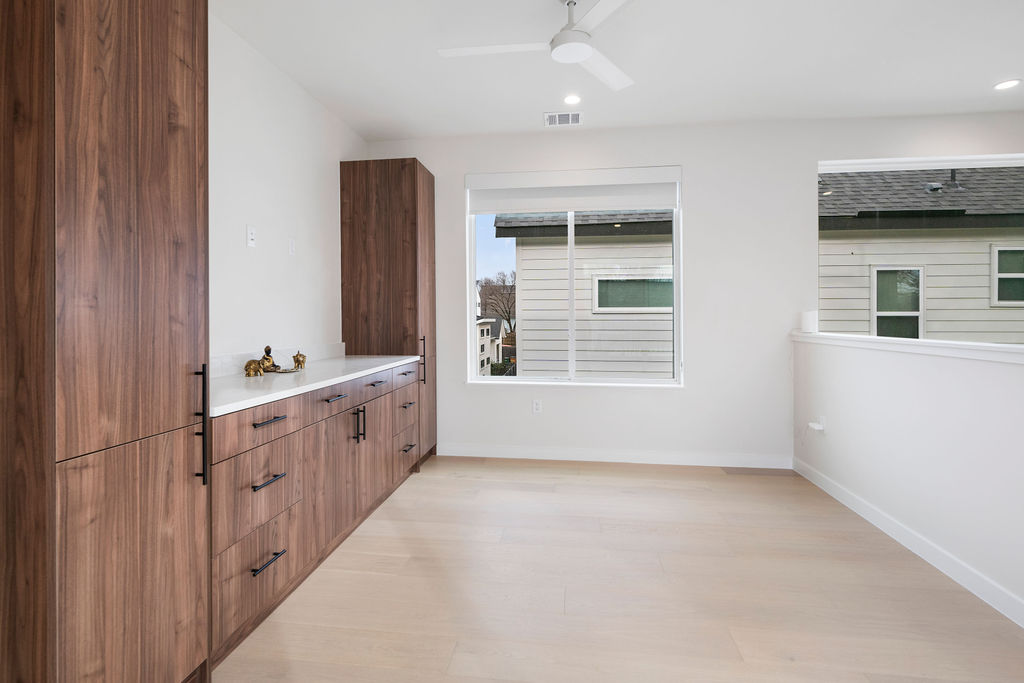 2912 East 13th Street Austin, TX 78702 - Photo 14 of 40 a large white kitchen with granite countertop a sink and dishwasher a stove with wooden floor