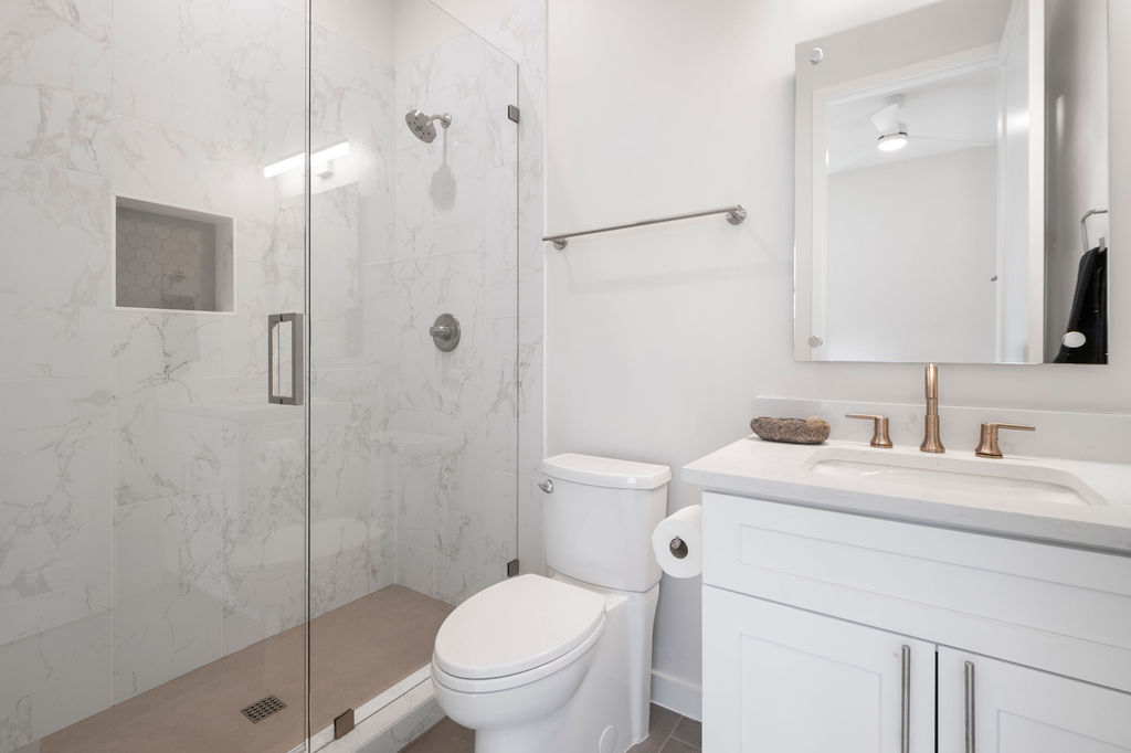 2912 East 13th Street Austin, TX 78702 - Photo 16 of 40 a bathroom with a toilet sink vanity and shower
