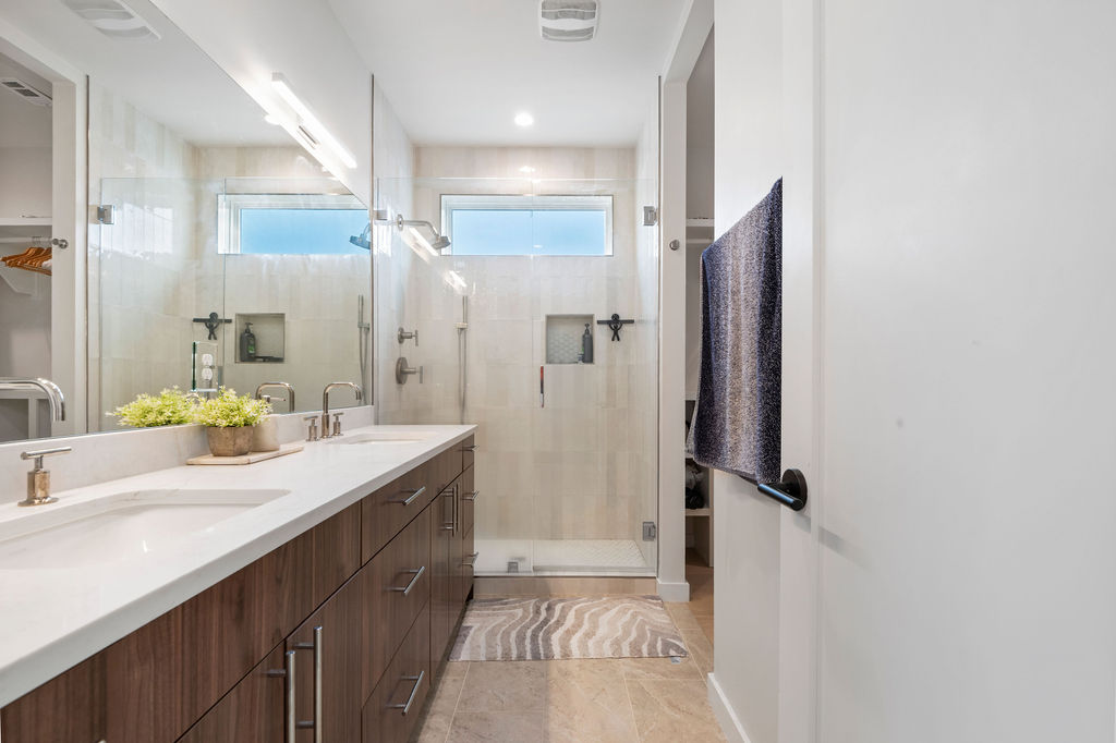 2912 East 13th Street Austin, TX 78702 - Photo 26 of 40 a bathroom with a double vanity sink mirror and shower