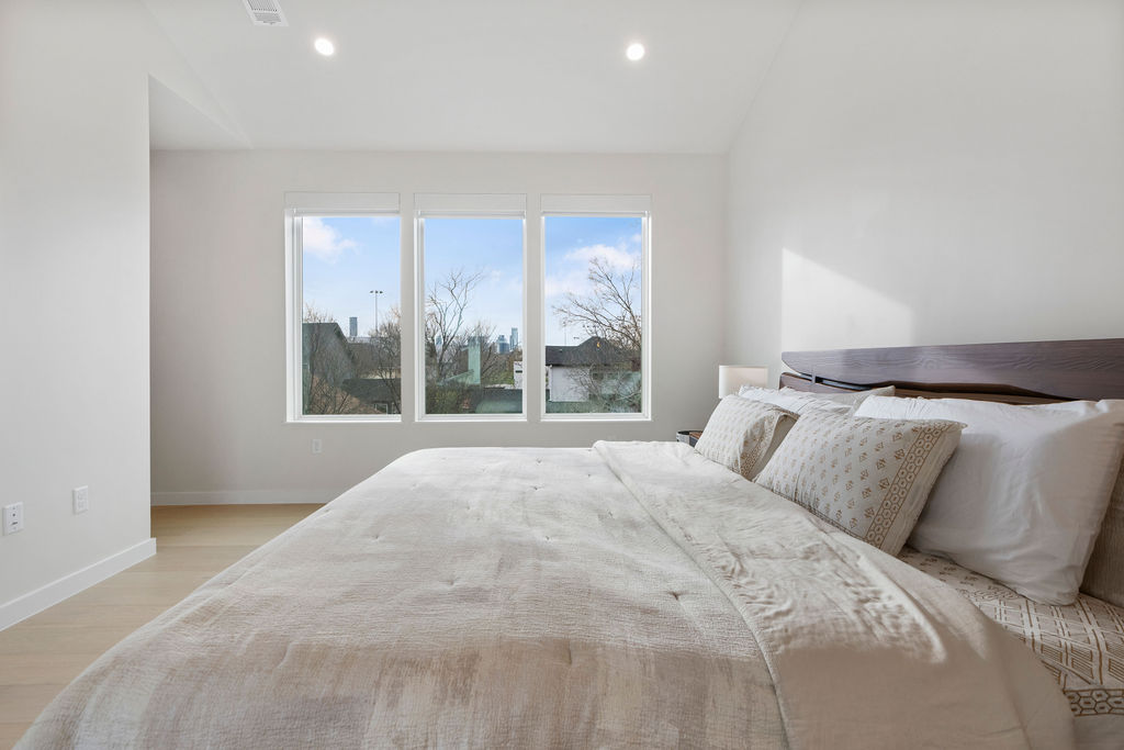 2912 East 13th Street Austin, TX 78702 - Photo 30 of 40 a bedroom with a large bed and a large window