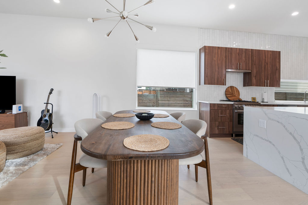 2912 East 13th Street Austin, TX 78702 - Photo 3 of 40 a kitchen with stainless steel appliances granite countertop a sink a stove and chairs