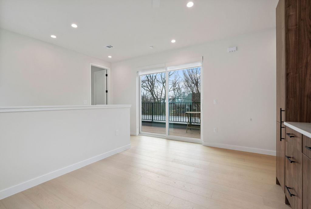 2912 East 13th Street Austin, TX 78702 - Photo 32 of 40 a view of an empty room with wooden floor and a window