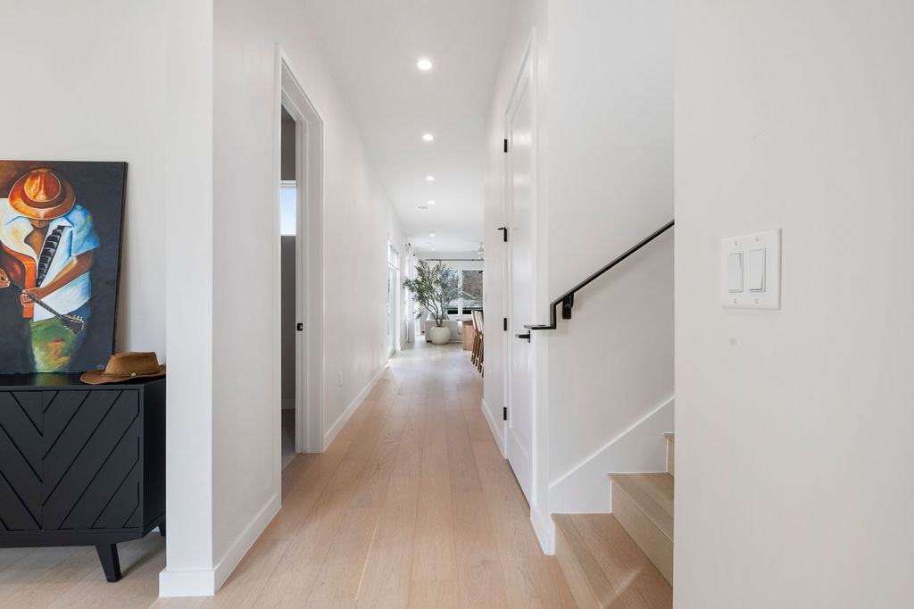 2912 East 13th Street Austin, TX 78702 - Photo 7 of 40 a view of a hallway with wooden floor and staircase