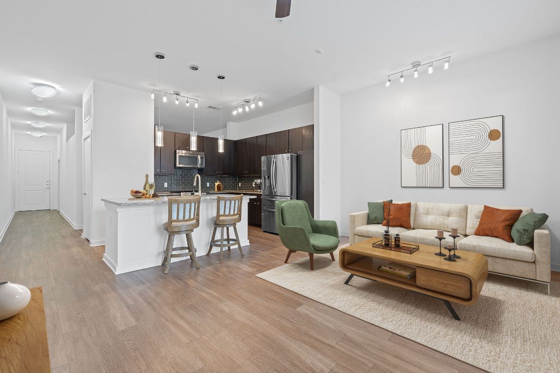 a living room with furniture and kitchen view