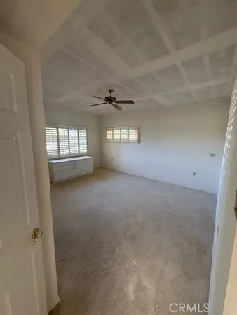 an empty room with a empty space and windows