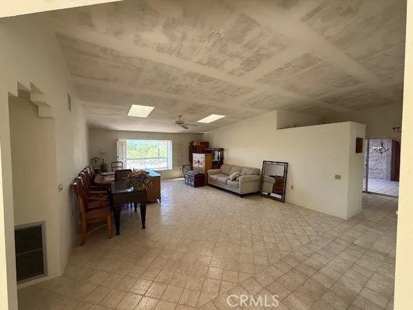 a living room with furniture and a piano
