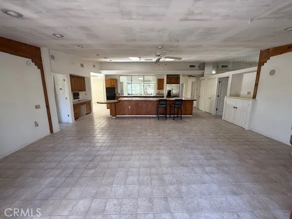 a view of empty room with wooden floor and window