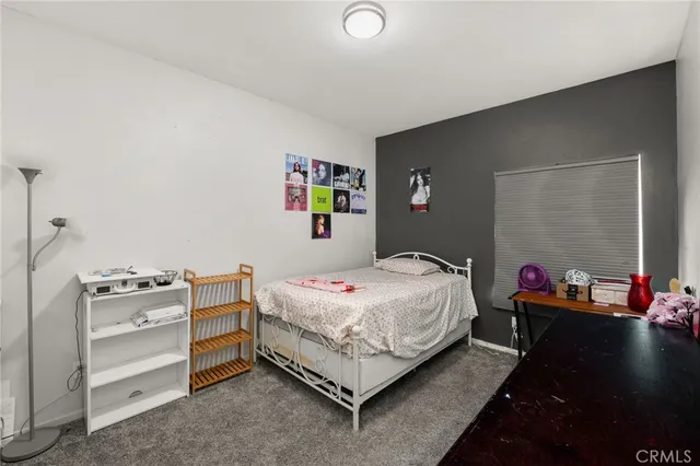 a bathroom with a sink a toilet a mirror and shower curtain