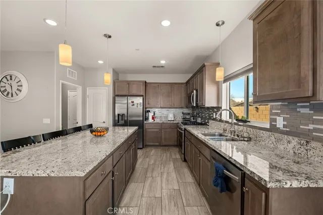 a large kitchen with a stove and a large window