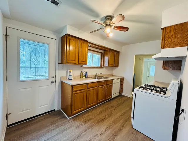 a kitchen with stainless steel appliances granite countertop a stove a sink dishwasher and a refrigerator