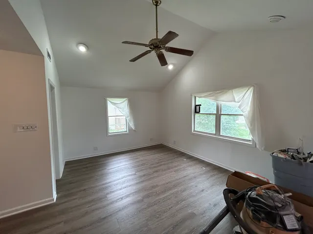 a view of workspace with wooden floor and windows